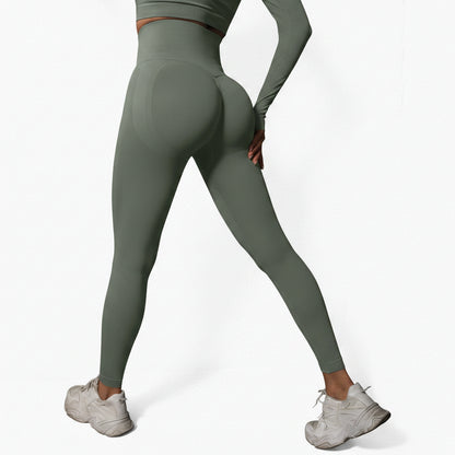 Person wearing green leggings and white sneakers