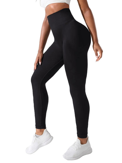 Person wearing black leggings and white sneakers against a white background
