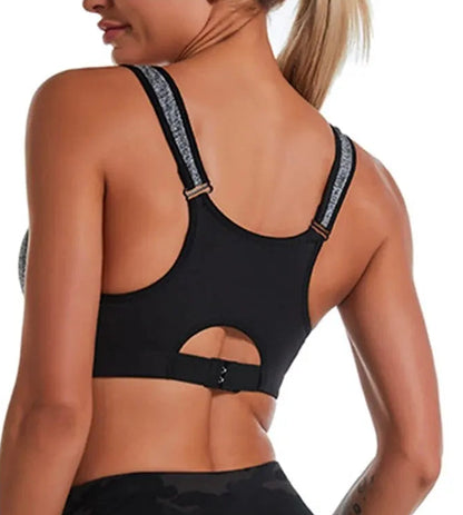 Black sports bra with cut-out design worn by a model on a white background
