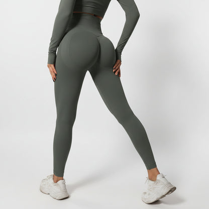 Person wearing green leggings and white sneakers