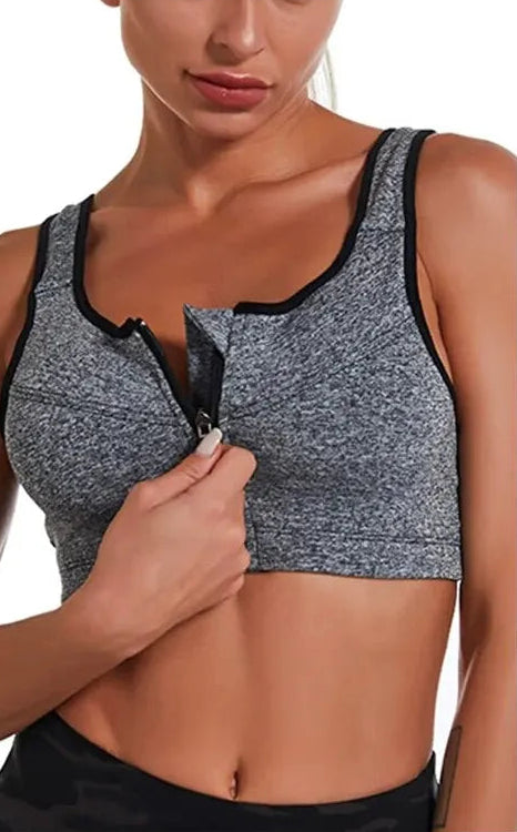 Gray sports bra with zipper detail on a model against a white background