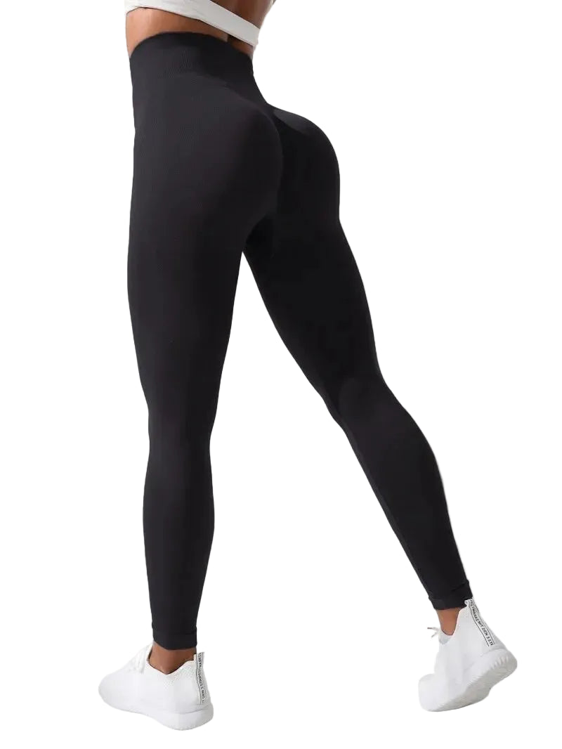 Person wearing black leggings with a white background