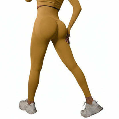 Person wearing mustard yellow leggings and white sneakers 