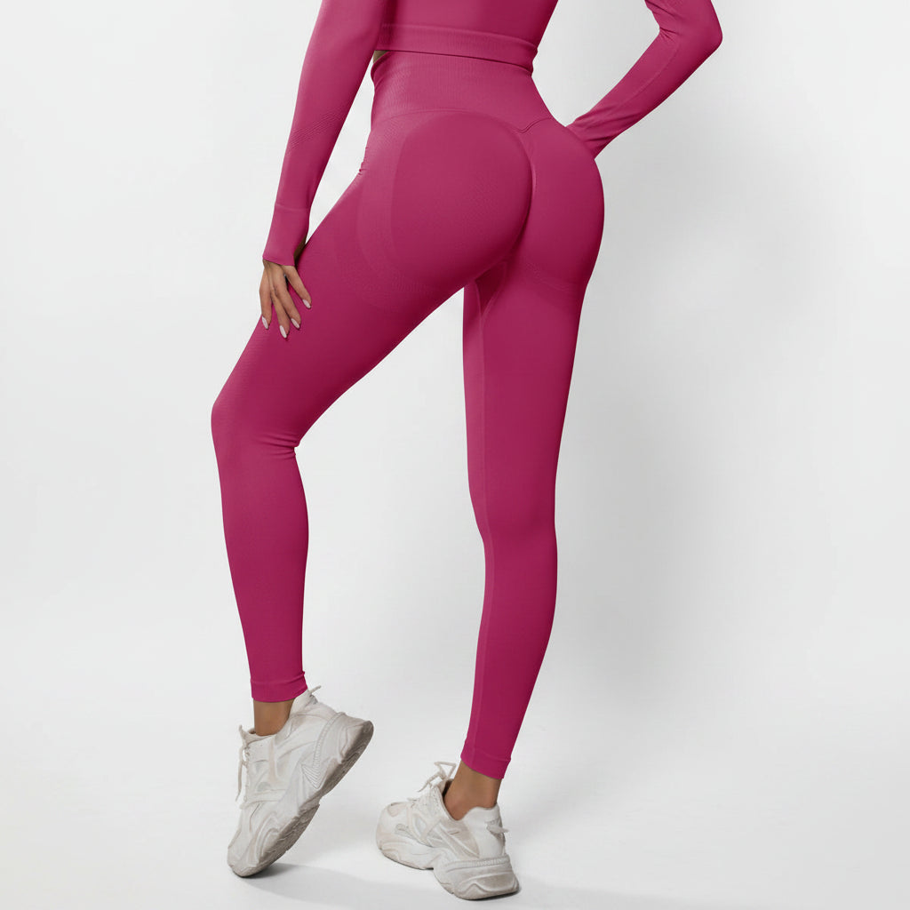 Person wearing bright pink athletic leggings and top