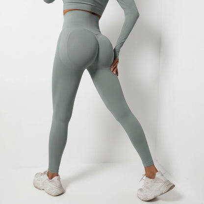Person wearing gray leggings and a cropped top