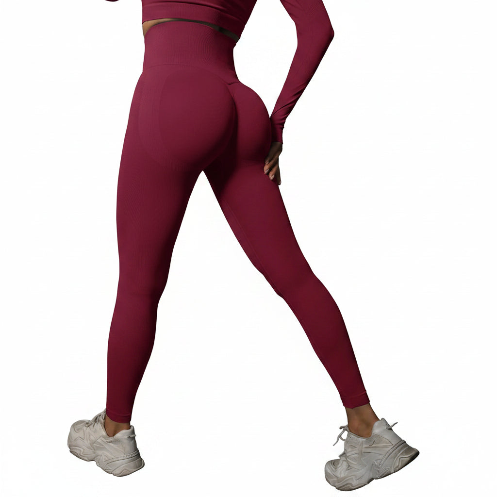 Person wearing maroon leggings and white sneakers