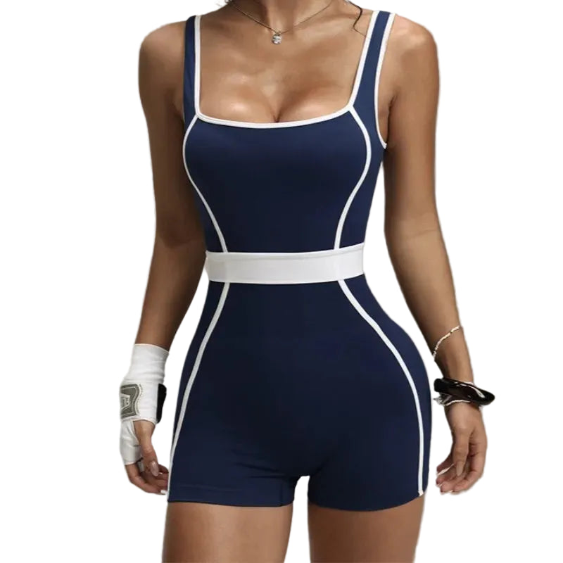 Navy blue and white jumpsuit worn by a model on a plain background