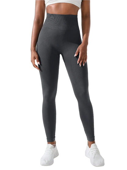 Person wearing dark gray leggings with a white background