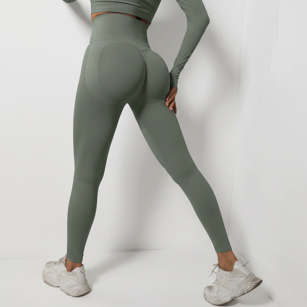 Person wearing green leggings and white sneakers