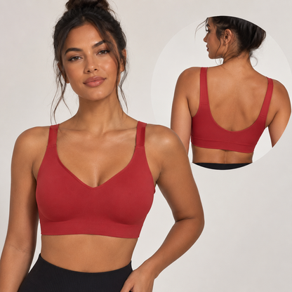 Woman wearing a red sports bra with a close-up of the back on a plain background