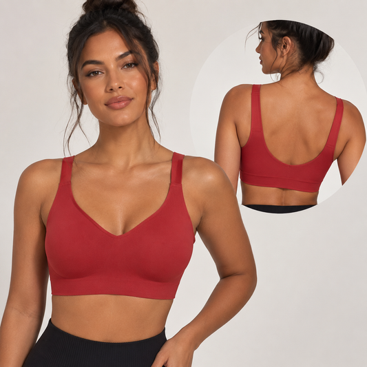 Woman wearing a red sports bra with a close-up of the back on a plain background